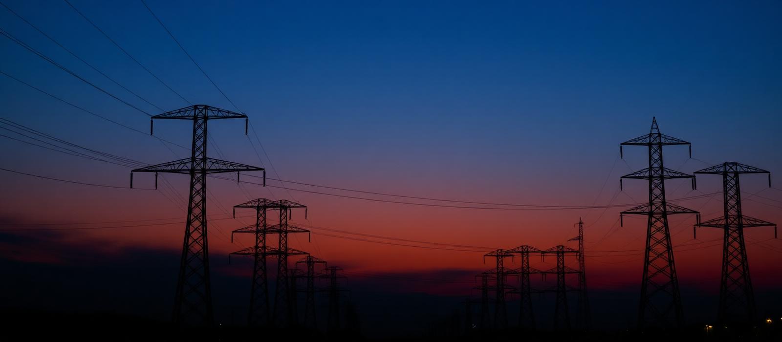 Electric transmission towers and power lines at dusk